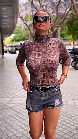 Walking braless in a sheer top for others to enjoy the view.'