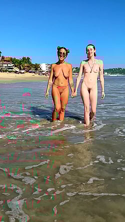 Two Naked Women Walking on the Beach'