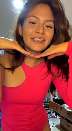 Newbie here but shy: Teen girl shows off her braces and pink shirt'